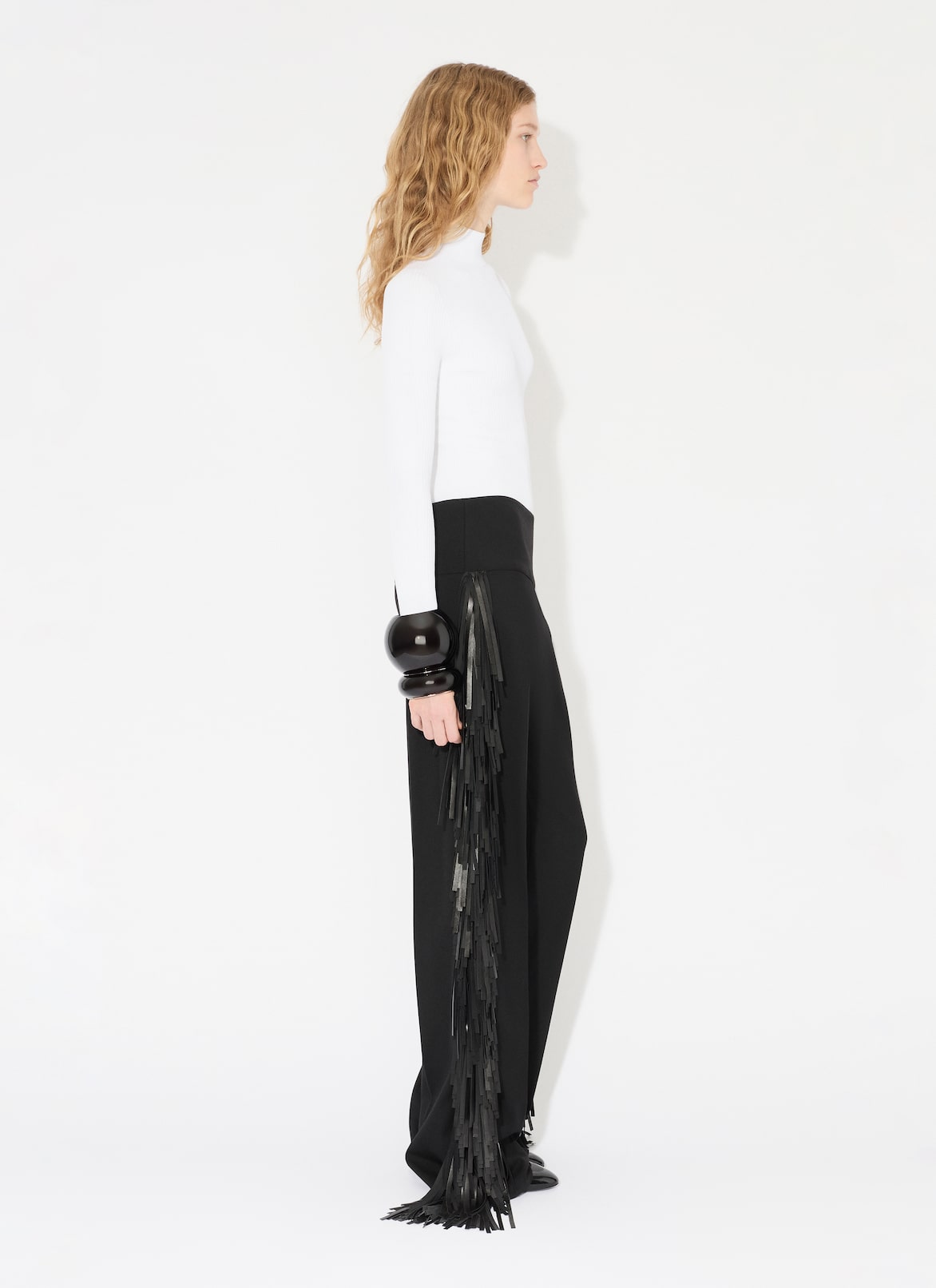 FRANSENHOSE AUS WOLLGABARDINE ALAÏA SCHWARZ FRANSENHOSE AUS WOLLGABARDINE